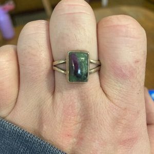 Silver ring with green and purple shiny stone